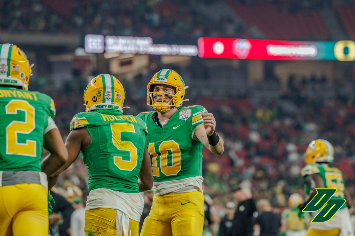 Oregon Ducks quarterback Bo Nix with wide receiver Traeshon Holden at the Vrbo Fiesta Bowl.